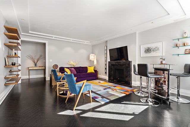 17 W 54th St Unit 6C, New York City, NY 10019 - living room featuring a raised ceiling, baseboards, a fireplace with raised hearth, and recessed lighting