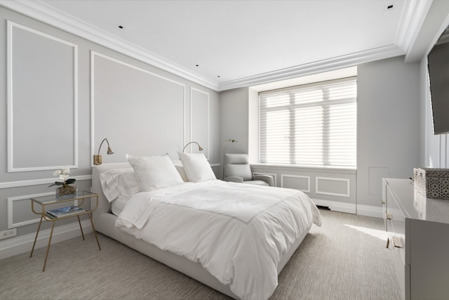 bedroom with ornamental molding, light colored carpet, and baseboards