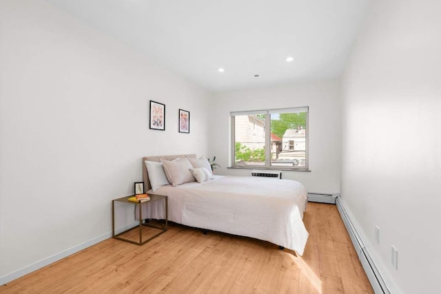 35 E 4th St Unit 3, New York City, NY 11218 - bedroom featuring a baseboard heating unit, a baseboard radiator, light wood-style floors, recessed lighting, and baseboards