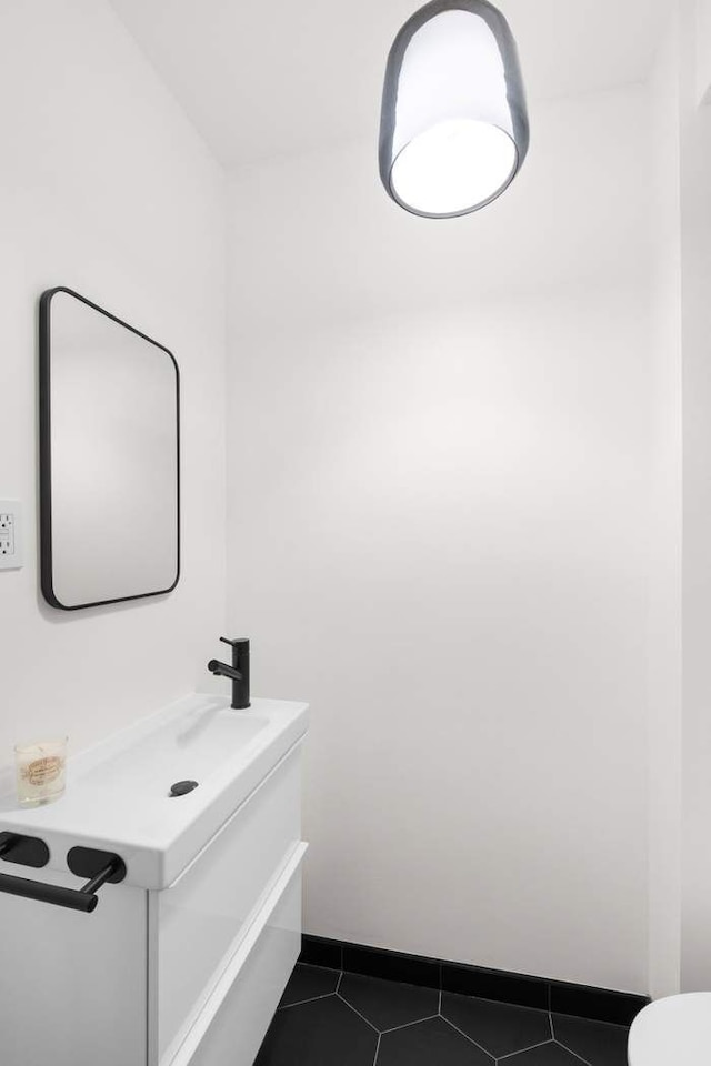 35 E 4th St Unit 3, New York City, NY 11218 - bathroom with vanity, tile patterned floors, and baseboards