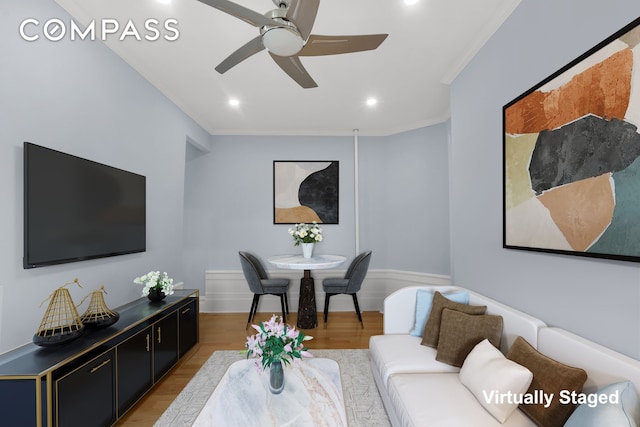 living room with crown molding, light wood-style flooring, a ceiling fan, and recessed lighting