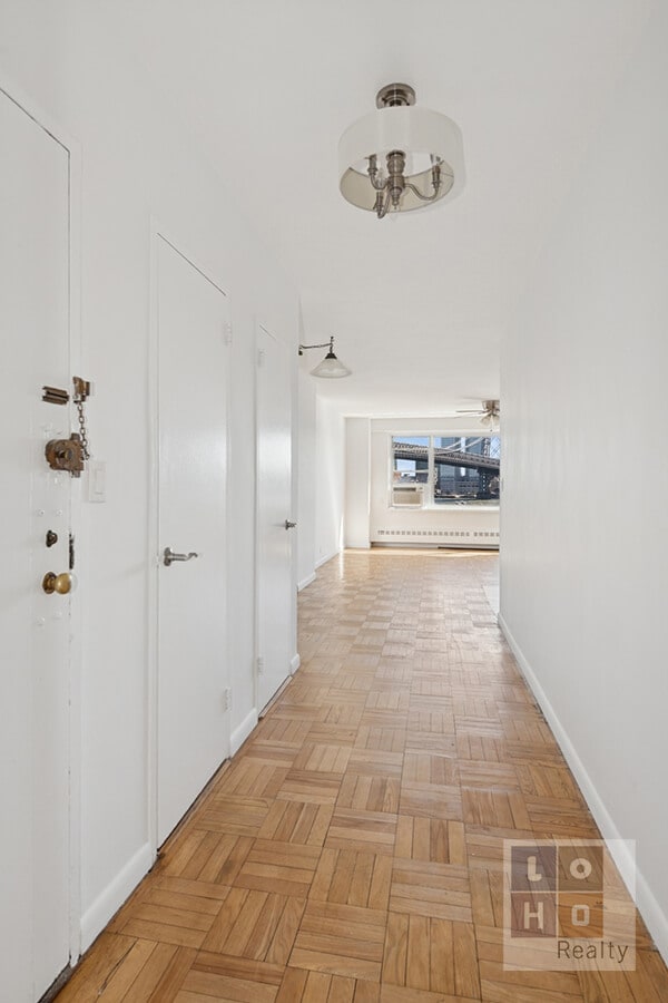 hallway featuring baseboards