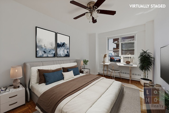 bedroom with a baseboard radiator and ceiling fan