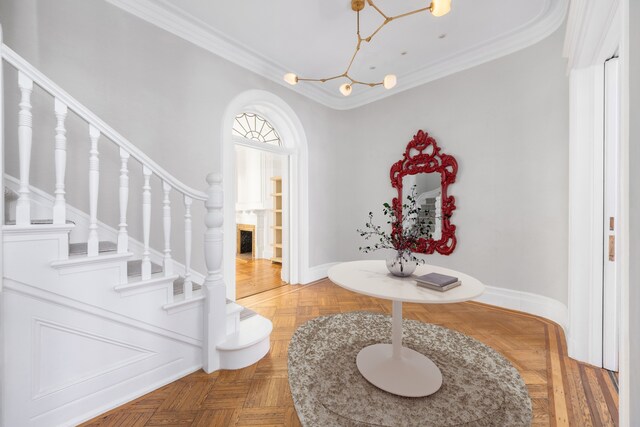 1342 Lexington Ave, New York City, NY 10128 - entrance foyer featuring a chandelier, baseboards, crown molding, and stairs