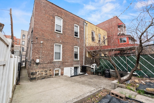30-53 23rd St, New York City, NY 11102 - rear view of house with brick siding and a patio area