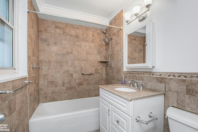 bathroom with tile walls, vanity, toilet, and bathtub / shower combination