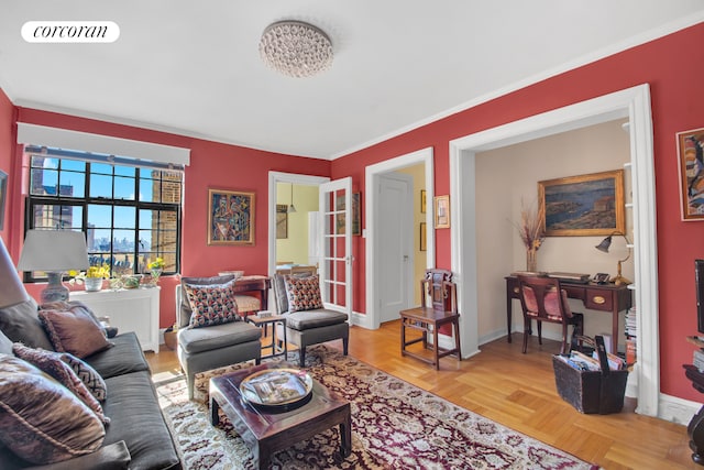 living room with baseboards, ornamental molding, and visible vents