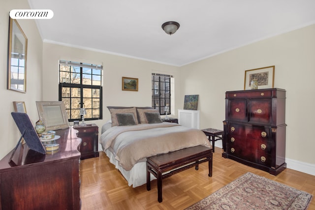 bedroom with crown molding and baseboards
