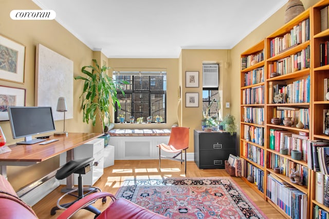 home office with ornamental molding, wall of books, visible vents, and an AC wall unit