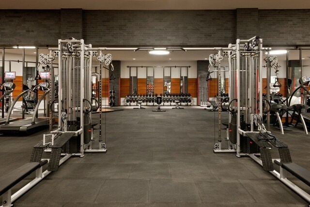 60 Riverside Blvd Unit 1908, New York City, NY 10069 - exercise room with a towering ceiling and brick wall
