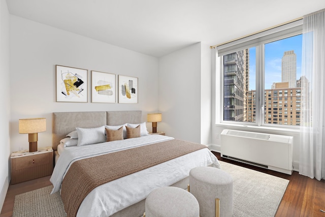 60 Riverside Blvd Unit 1908, New York City, NY 10069 - bedroom with a city view, wood finished floors, and radiator heating unit