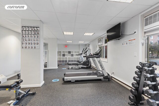 575 Main St Unit 903, New York City, NY 10044 - gym featuring a paneled ceiling and baseboards