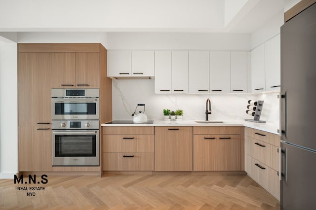 22-54 46th St Unit 504, New York City, NY 11105 - kitchen featuring stainless steel appliances, a sink, light countertops, and light brown cabinetry