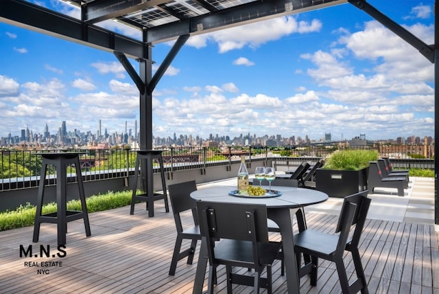 22-54 46th St Unit 504, New York City, NY 11105 - wooden terrace with a view of skyline and outdoor dining space