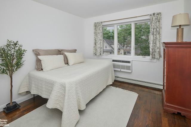 bedroom with a baseboard radiator, a wall mounted AC, and dark wood-type flooring