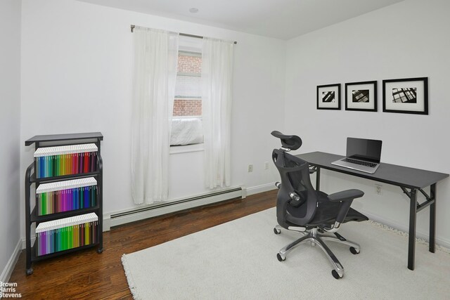 office with baseboards, wood finished floors, and baseboard heating