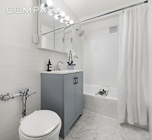 13 W 13th St Unit 6Js, New York City, NY 10011 - full bathroom featuring tile walls, vanity, shower / bath combination with curtain, toilet, and marble look tiles