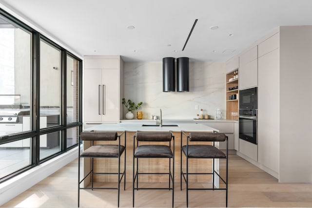 1025 Pacific St Unit 2A, New York City, NY 11238 - kitchen with black appliances, a sink, modern cabinets, and white cabinetry