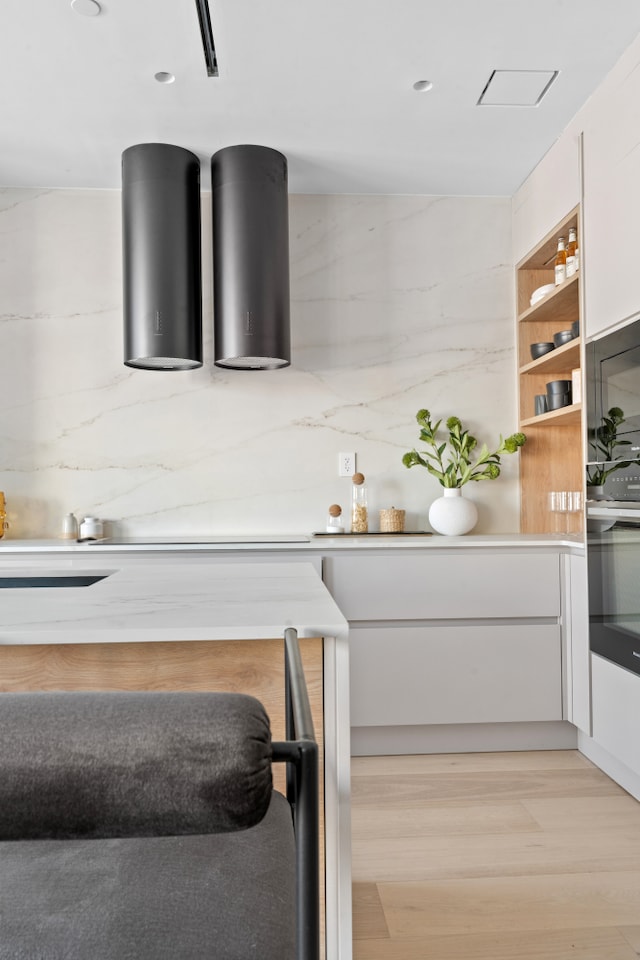 1025 Pacific St Unit 2A, New York City, NY 11238 - kitchen featuring white cabinetry, light wood-style flooring, light countertops, and open shelves