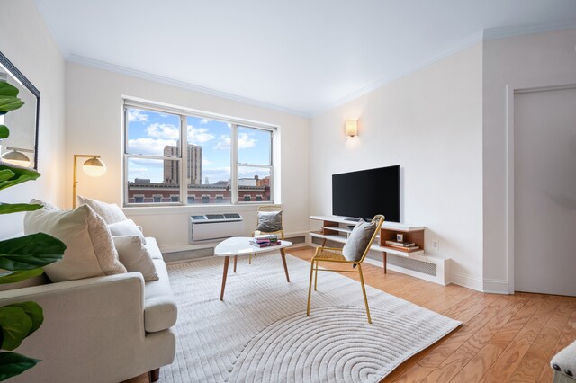 1787 Madison Ave Unit 402, New York City, NY 10035 - living room with crown molding, wood finished floors, a wall unit AC, and baseboards