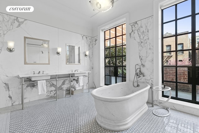 full bathroom with a freestanding bath, visible vents, and a sink