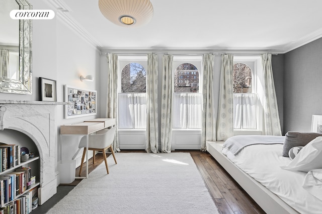 bedroom with hardwood / wood-style floors and ornamental molding