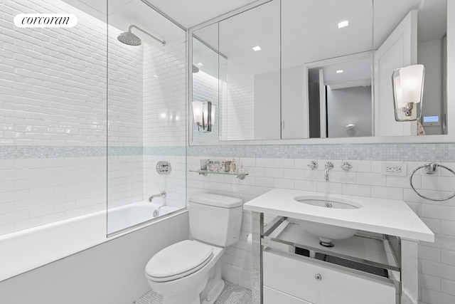 full bathroom featuring vanity, visible vents, toilet, tile walls, and shower / bathing tub combination
