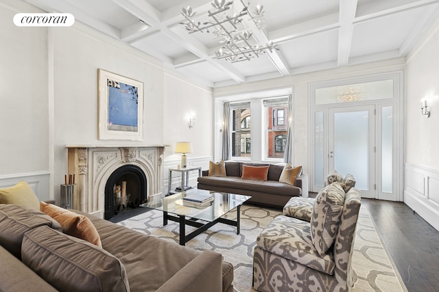 living room with visible vents, an inviting chandelier, beamed ceiling, wood finished floors, and coffered ceiling