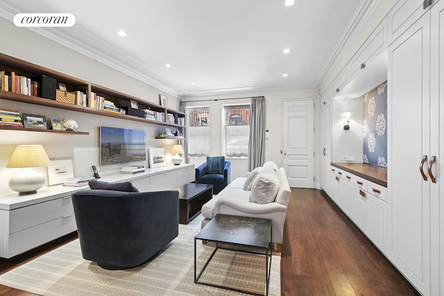 living room featuring dark wood finished floors, ornamental molding, visible vents, and built in desk