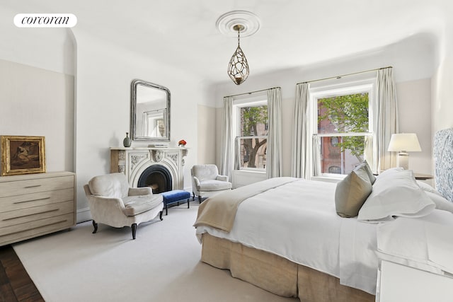 bedroom with visible vents and a fireplace