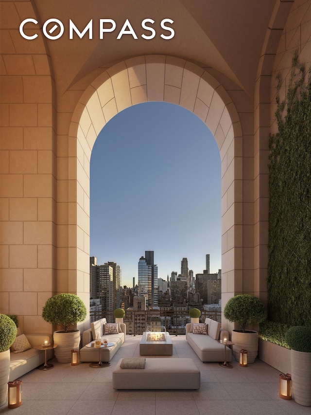view of patio featuring a city view and a fire pit