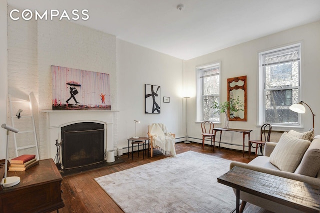 217 W 15th St, New York City, NY 10011 - living area with wood-type flooring, a fireplace with flush hearth, and a baseboard heating unit