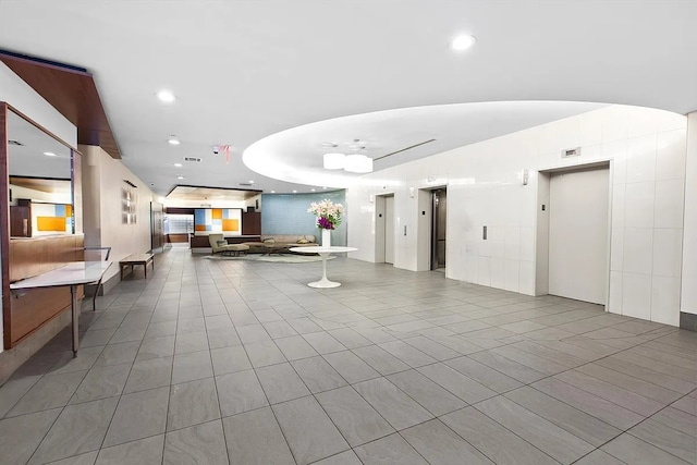 310 E 46th St Unit 18J, New York City, NY 10017 - building lobby featuring recessed lighting and vaulted ceiling