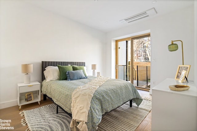 323 S 5th St Unit 1, New York City, NY 11211 - bedroom with access to exterior, wood finished floors, and baseboards