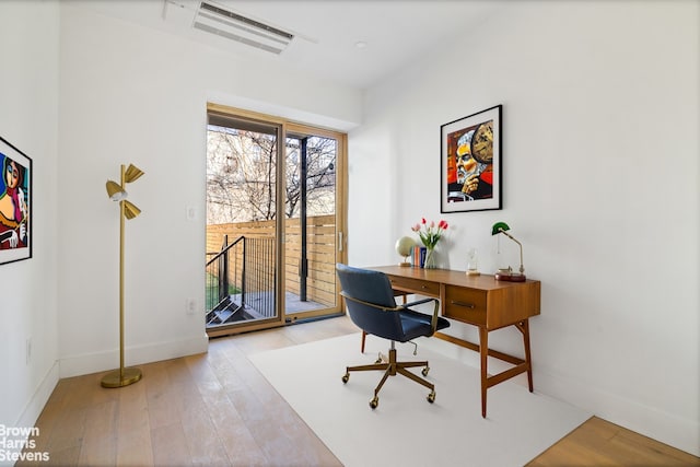 office space featuring wood finished floors and baseboards
