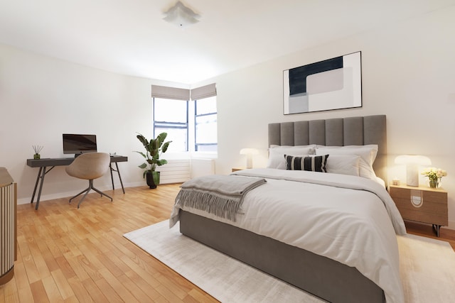 bedroom featuring light wood-style floors and baseboards