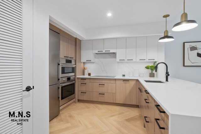 22-54 46th St Unit 704, New York City, NY 11105 - kitchen with a sink, black electric stovetop, a peninsula, light brown cabinets, and recessed lighting