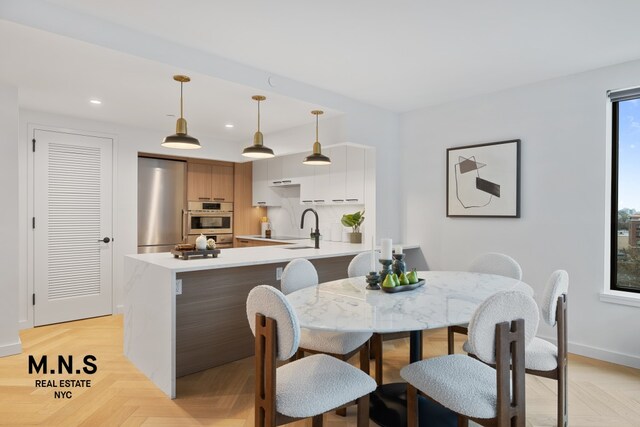 22-54 46th St Unit 704, New York City, NY 11105 - dining room featuring baseboards and recessed lighting