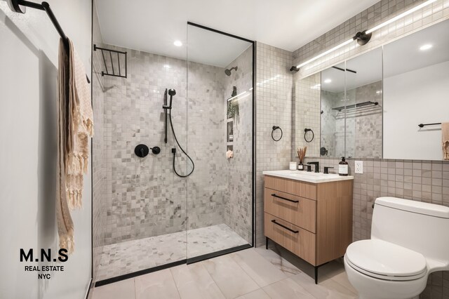 22-54 46th St Unit 704, New York City, NY 11105 - full bathroom featuring tile walls, vanity, a tile shower, toilet, and recessed lighting