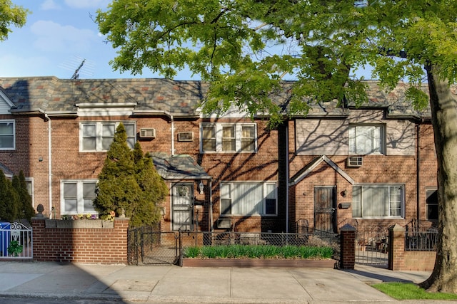 50-21 40th St, New York City, NY 11104 - view of front facade featuring a gate, a fenced front yard, and brick siding