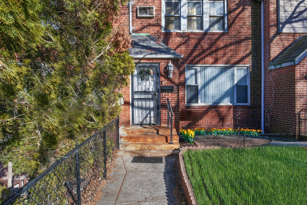 50-21 40th St, New York City, NY 11104 - entrance to property featuring brick siding and fence