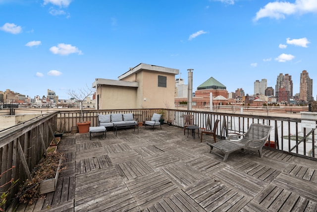 wooden terrace with outdoor lounge area and a city view