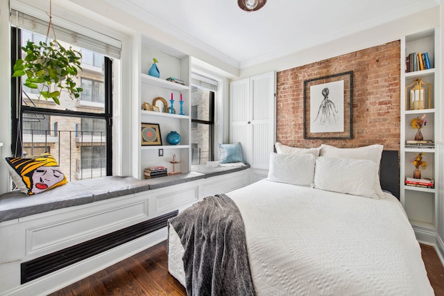 bedroom featuring crown molding, brick wall, and dark wood-style floors