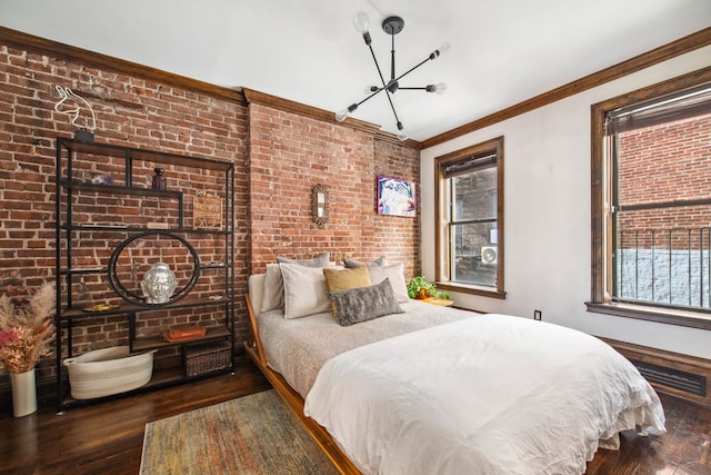 bedroom featuring a chandelier, ornamental molding, wood finished floors, and visible vents