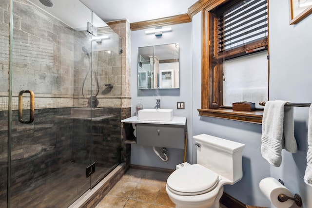 full bath featuring stone finish flooring, a stall shower, vanity, baseboards, and toilet