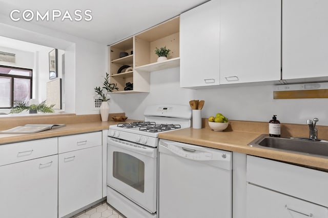 372 5th Ave Unit 9J, New York City, NY 10018 - kitchen featuring white appliances, open shelves, a sink, white cabinetry, and light countertops
