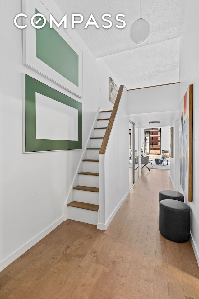 372 5th Ave Unit 9J, New York City, NY 10018 - staircase featuring hardwood / wood-style flooring and baseboards