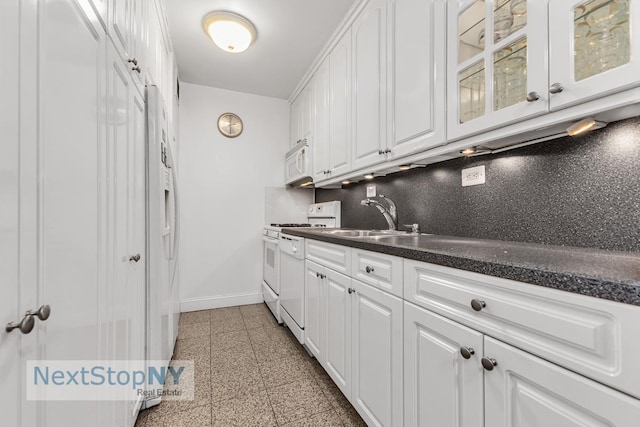 245 E 54th St Unit 22A, New York City, NY 10022 - kitchen featuring white appliances, baseboards, white cabinets, and granite tiled floors
