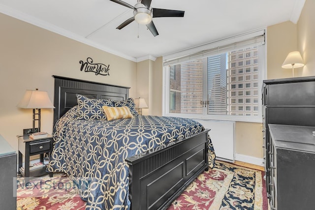 245 E 54th St Unit 22A, New York City, NY 10022 - bedroom featuring ornamental molding, wood finished floors, ceiling fan, and baseboards