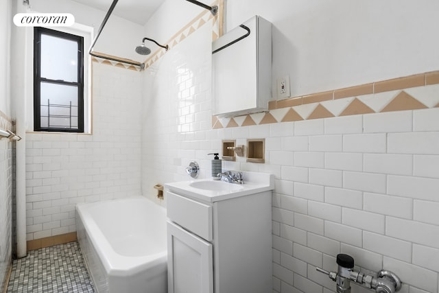 bathroom with vanity, shower / tub combination, tile patterned flooring, and tile walls